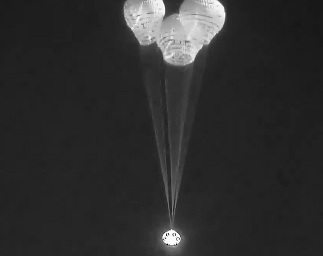 Animation of Starliner floating under three parachutes.