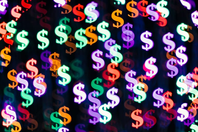 Multi Colored Bling Bling Dollar Sign Shape Bokeh Backdrop on Dark Background, Finance Concept.