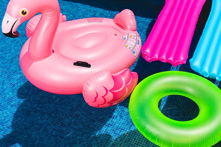 inflatable pool toys sitting on top of pool