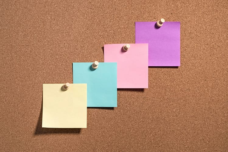 4 post it notes on a cork board; talking points for investor negotiations