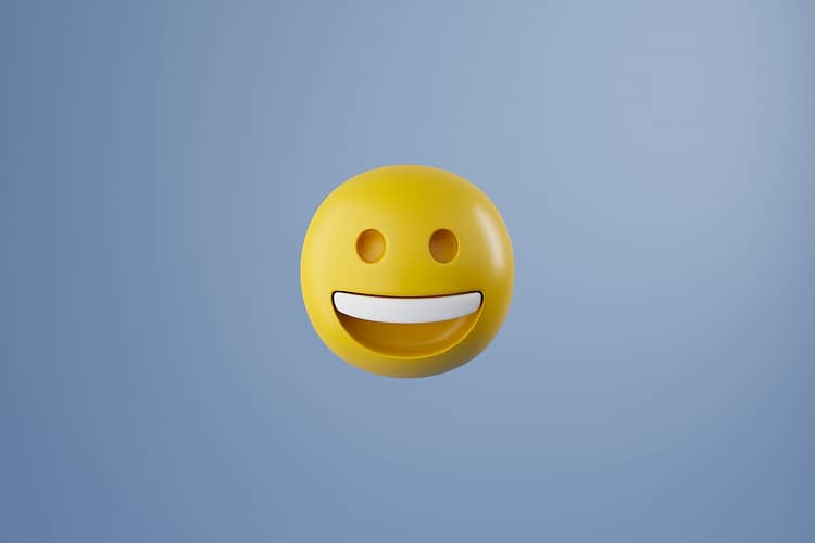 Computer graphics of yellow smiling round emoji emoticon isolated on pastel blue background. Happy face emoticon.